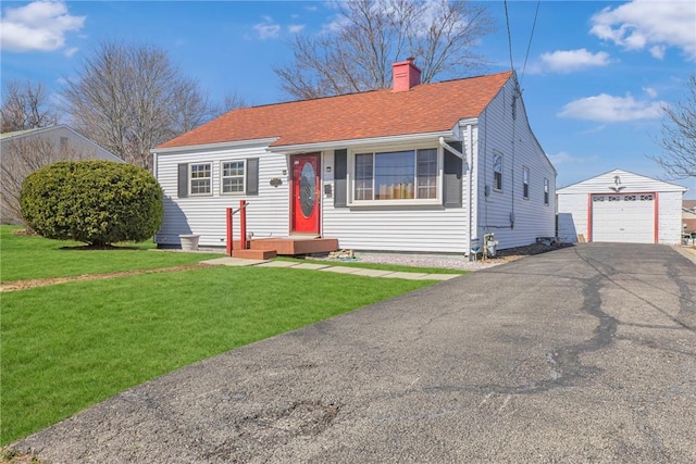 view of front of property with driveway, a chimney, an outdoor structure, a front lawn, and a garage