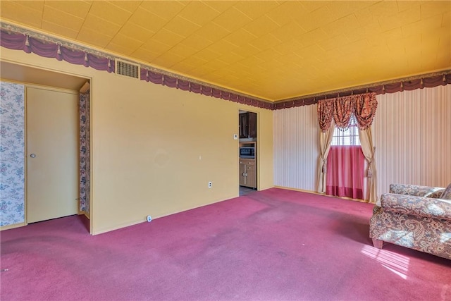 unfurnished room featuring visible vents and carpet flooring