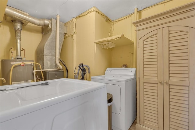 laundry area with water heater, laundry area, and independent washer and dryer