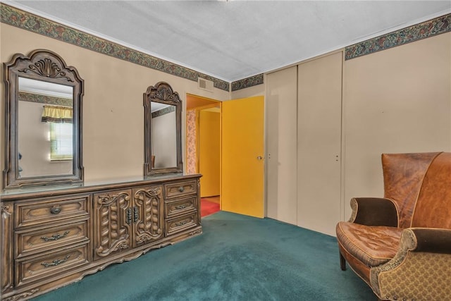 sitting room featuring visible vents and carpet floors