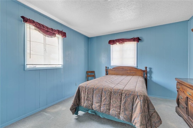 carpeted bedroom featuring a textured ceiling