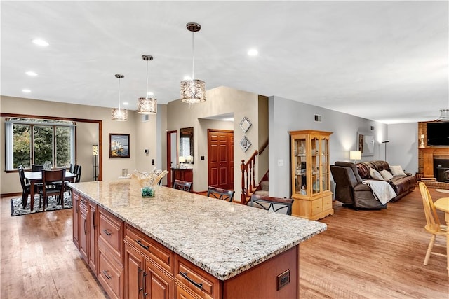 kitchen featuring light stone counters, recessed lighting, and light wood-type flooring