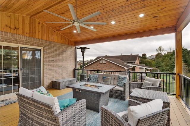 wooden terrace featuring an outdoor living space with a fire pit and ceiling fan