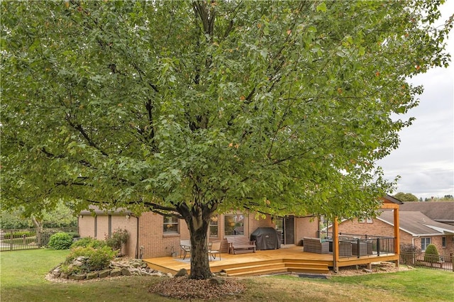 view of yard with a wooden deck and fence