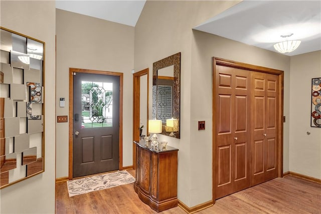 entrance foyer featuring light wood-type flooring and baseboards