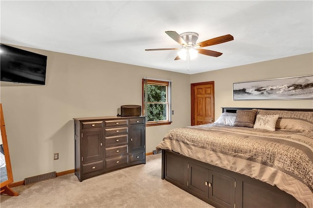 bedroom featuring baseboards, light carpet, visible vents, and a ceiling fan