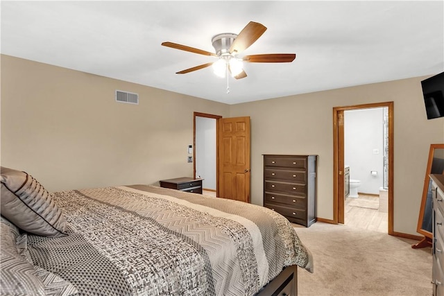 bedroom featuring a ceiling fan, baseboards, visible vents, light carpet, and connected bathroom