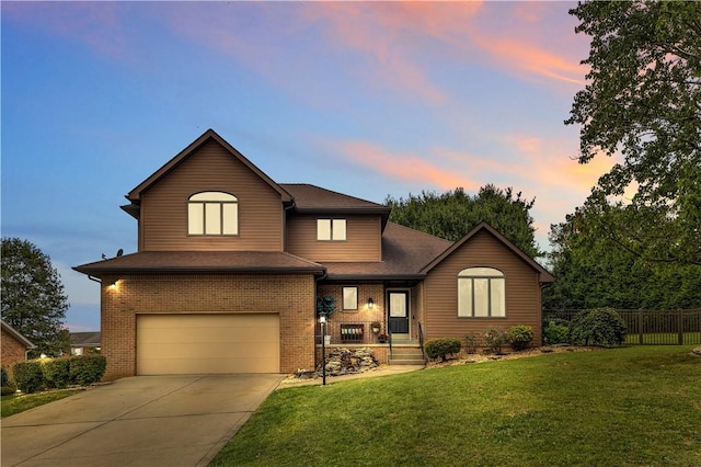 view of front of property featuring fence, a front lawn, concrete driveway, a garage, and brick siding