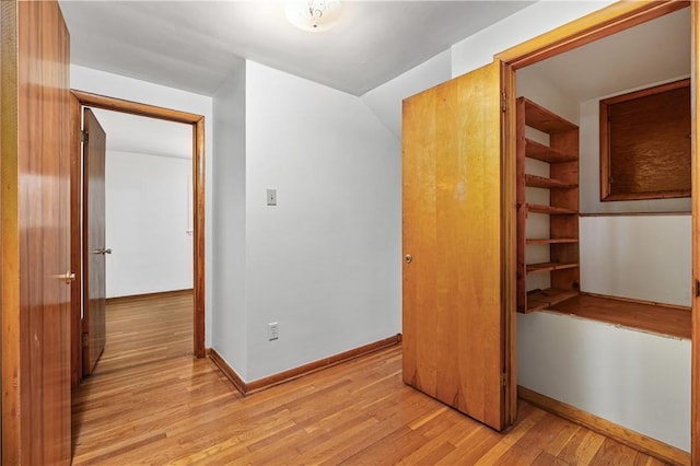 unfurnished bedroom featuring light wood-style flooring and baseboards