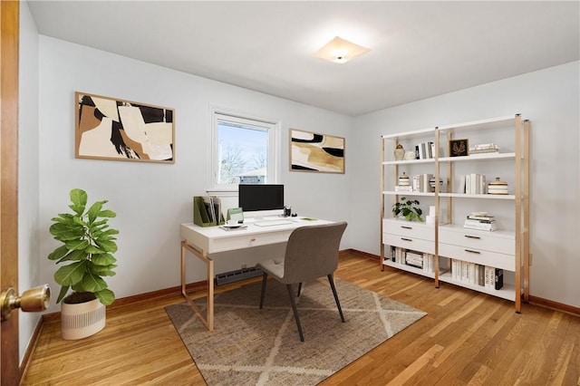 office area featuring light wood-style flooring and baseboards