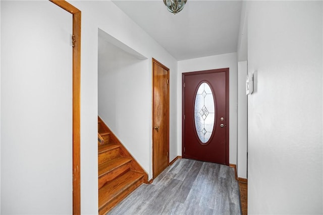 foyer featuring wood finished floors and stairs