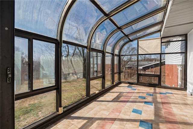 unfurnished sunroom featuring lofted ceiling