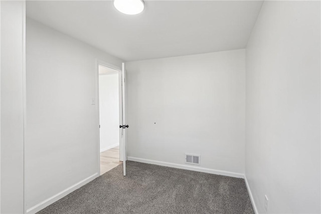 unfurnished room featuring visible vents, baseboards, and carpet