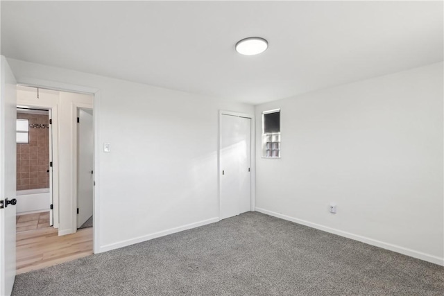 empty room with light carpet and baseboards