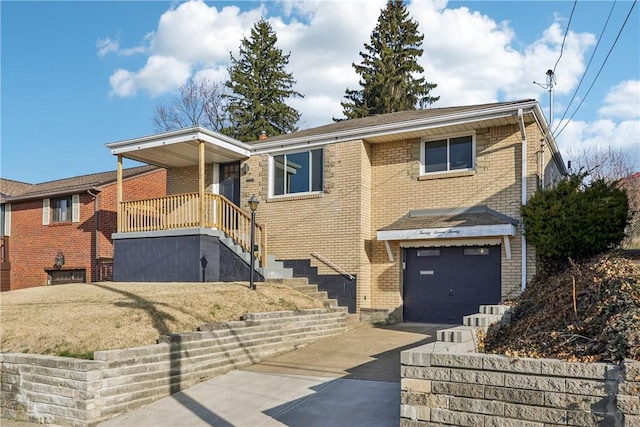 single story home featuring a garage, brick siding, and driveway