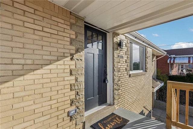 property entrance featuring brick siding