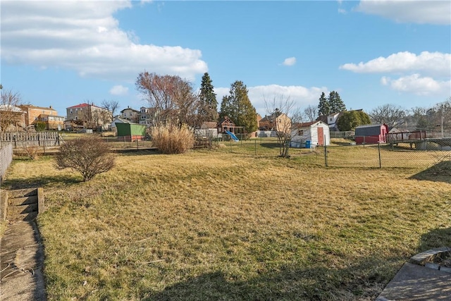 view of yard featuring a playground and fence