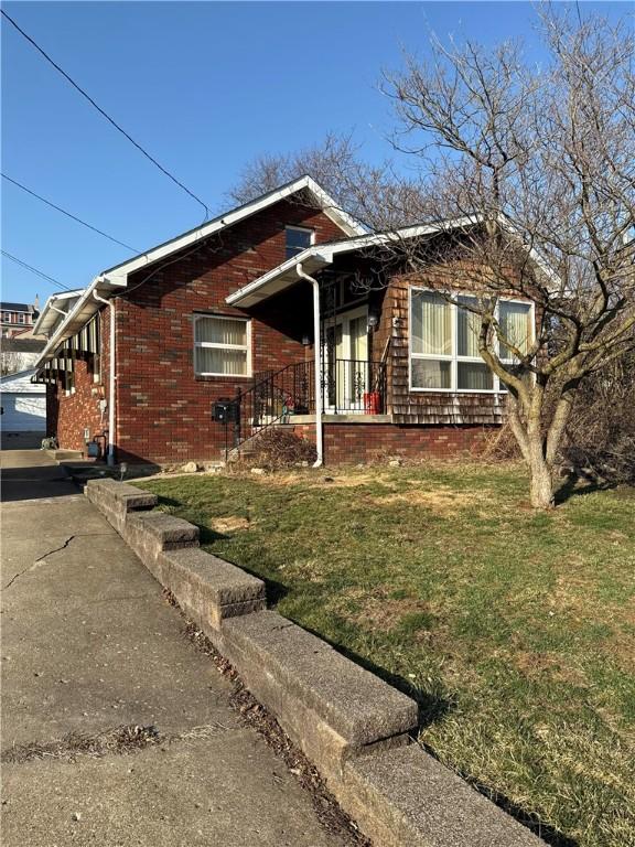 ranch-style home with brick siding and a front lawn