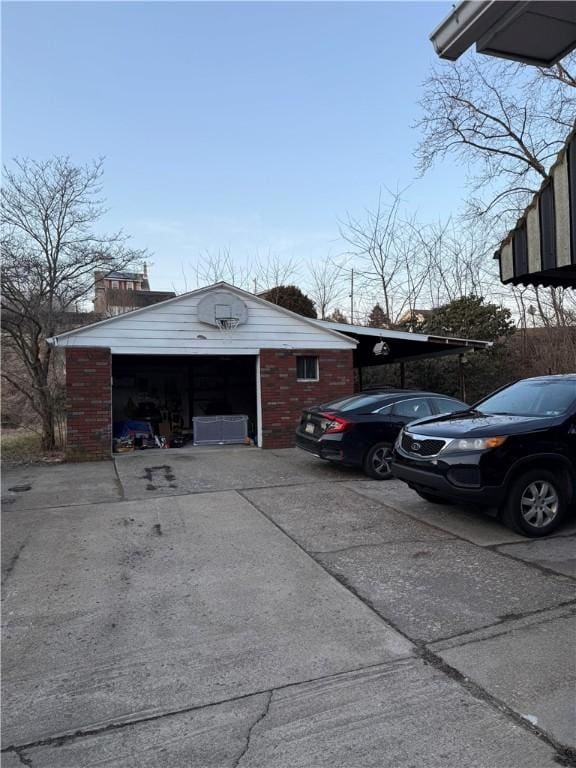 view of home's exterior with a garage, an outdoor structure, and concrete driveway