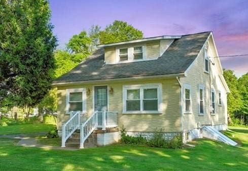 bungalow-style home featuring a yard