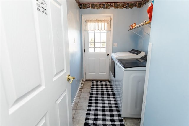 laundry area with light tile patterned floors, laundry area, washer and dryer, and baseboards