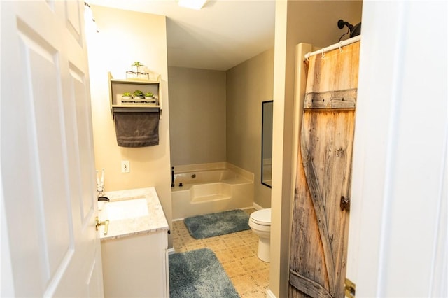 bathroom featuring toilet, tile patterned floors, a bath, and vanity