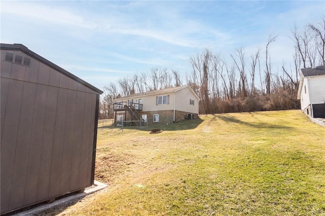 view of yard featuring an outbuilding and stairs