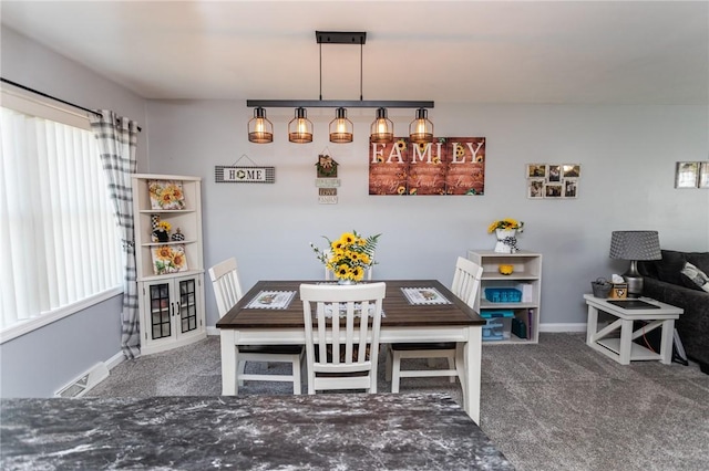 dining space featuring plenty of natural light, visible vents, baseboards, and carpet