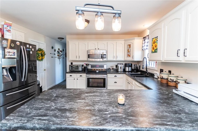 kitchen with a sink, a toaster, white cabinetry, and stainless steel appliances