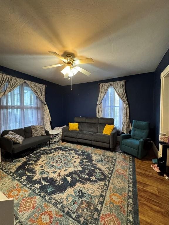 living room with a ceiling fan and wood finished floors