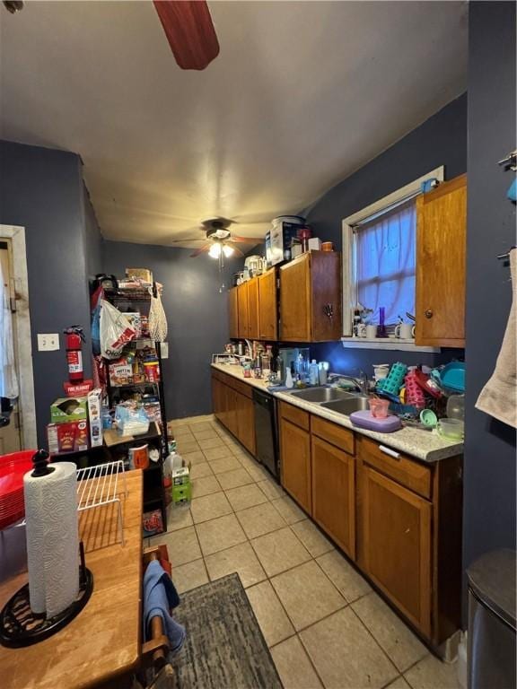 kitchen with a ceiling fan, a sink, light tile patterned flooring, light countertops, and dishwasher