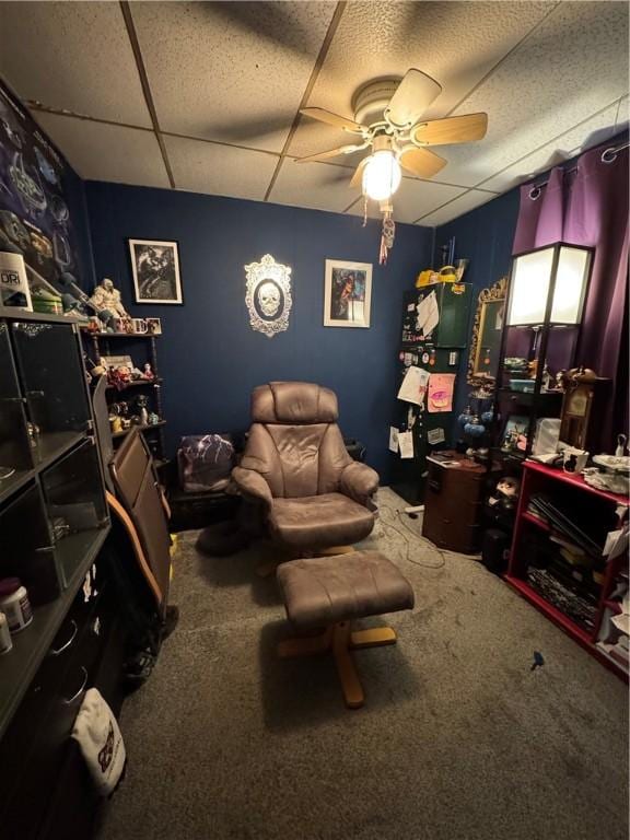 interior space featuring a drop ceiling and a ceiling fan