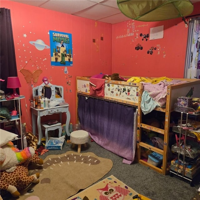 bedroom featuring carpet flooring and a drop ceiling