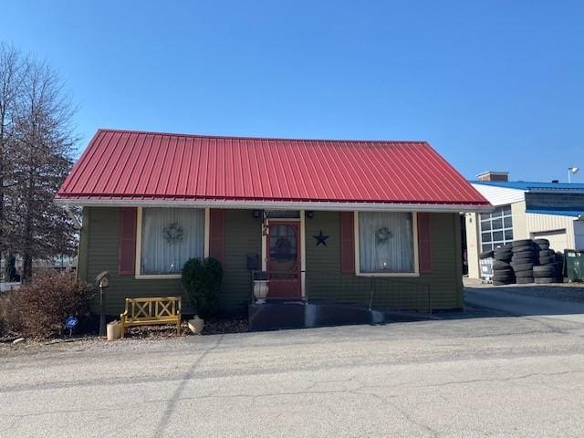 view of front of home featuring a porch and metal roof