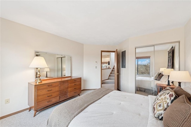 bedroom featuring electric panel, light colored carpet, a closet, and baseboards