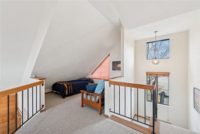 bedroom with multiple windows, baseboards, lofted ceiling, and carpet floors