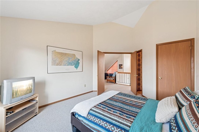 carpeted bedroom featuring baseboards and lofted ceiling