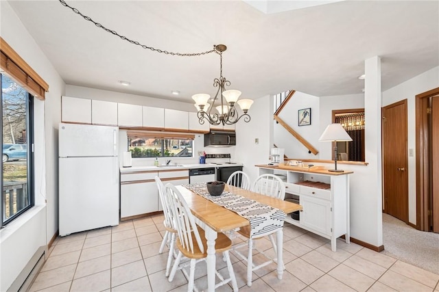 dining room featuring baseboards, baseboard heating, a chandelier, and light tile patterned flooring