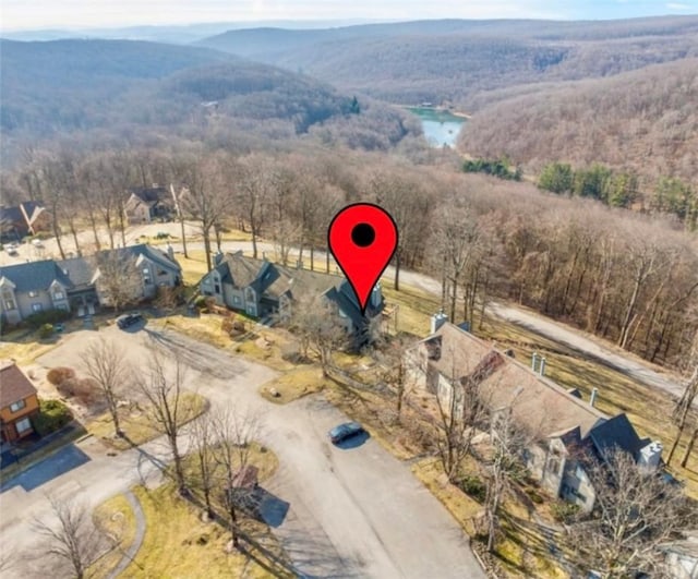 drone / aerial view with a wooded view