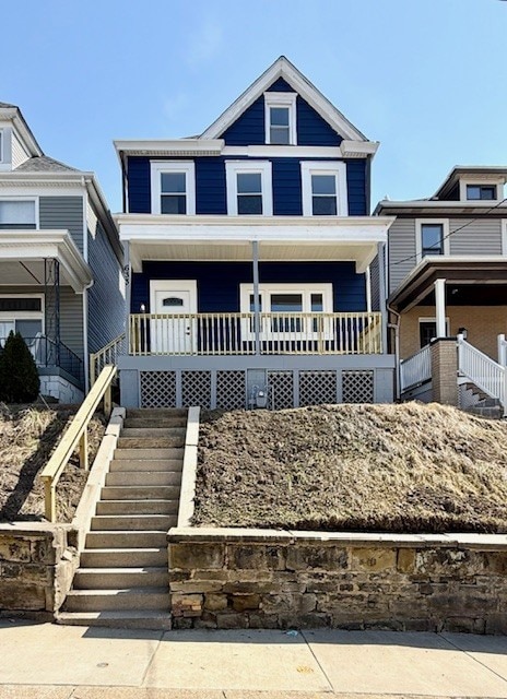 view of front facade featuring a porch and stairs