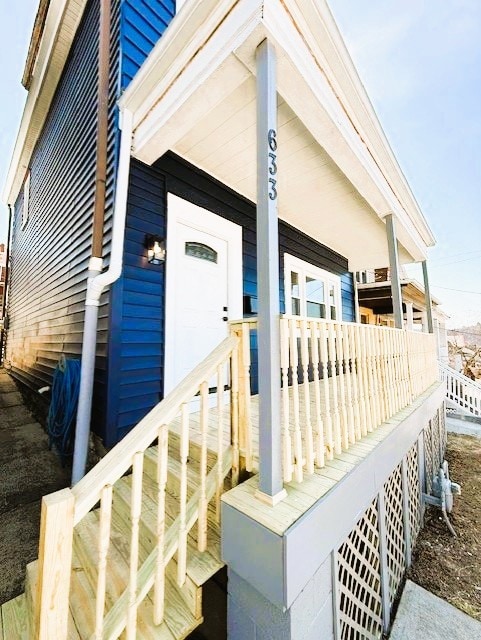 view of exterior entry with covered porch