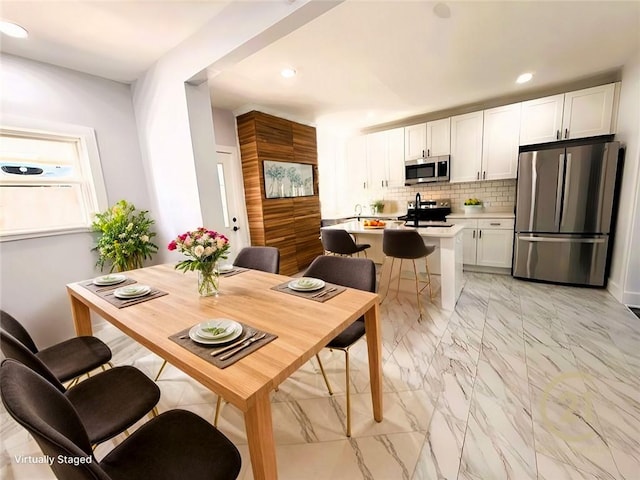 dining area featuring recessed lighting and marble finish floor