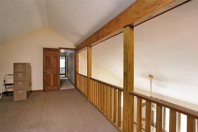 hall with lofted ceiling and carpet floors