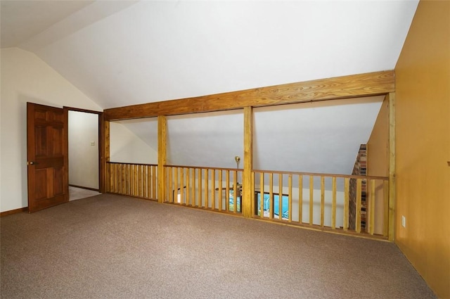 spare room featuring lofted ceiling and carpet floors