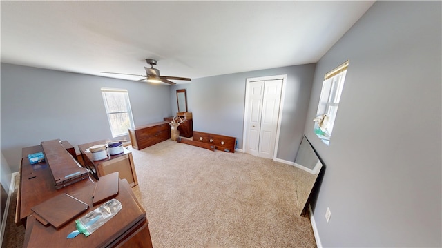 office with carpet flooring, a ceiling fan, and baseboards