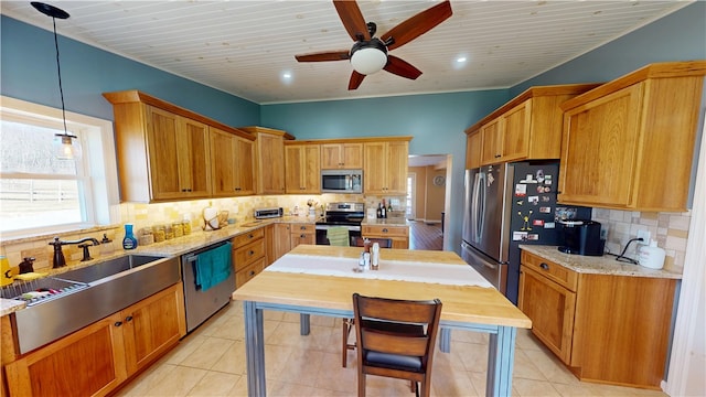 kitchen with a ceiling fan, a sink, backsplash, stainless steel appliances, and light tile patterned floors