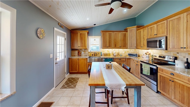 kitchen with light tile patterned floors, tasteful backsplash, and appliances with stainless steel finishes