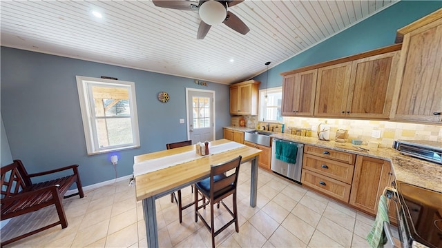 kitchen featuring tasteful backsplash, light tile patterned floors, stainless steel appliances, a ceiling fan, and a sink