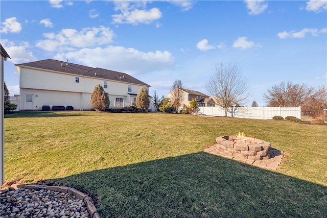 view of yard with fence and an outdoor fire pit