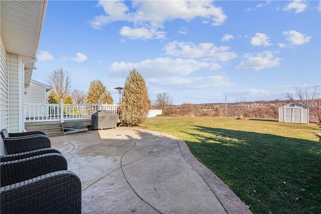 view of yard featuring a shed, an outdoor structure, and a patio